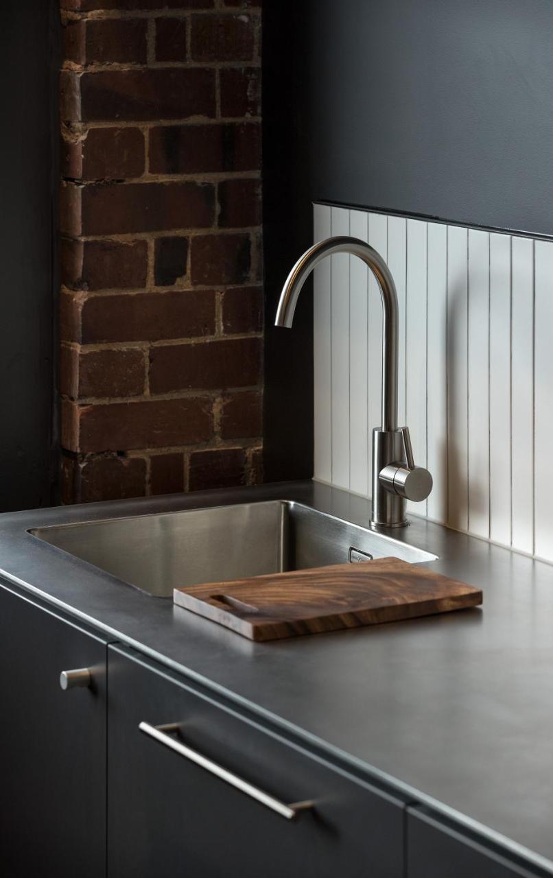 The Chamberson Hotell Dunedin Eksteriør bilde A kitchen sink with a wooden cutting board